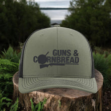 Moco Shirts olive green and black mesh Richardson 112 snapback hat with Guns & Cornbread logo on a tree stump